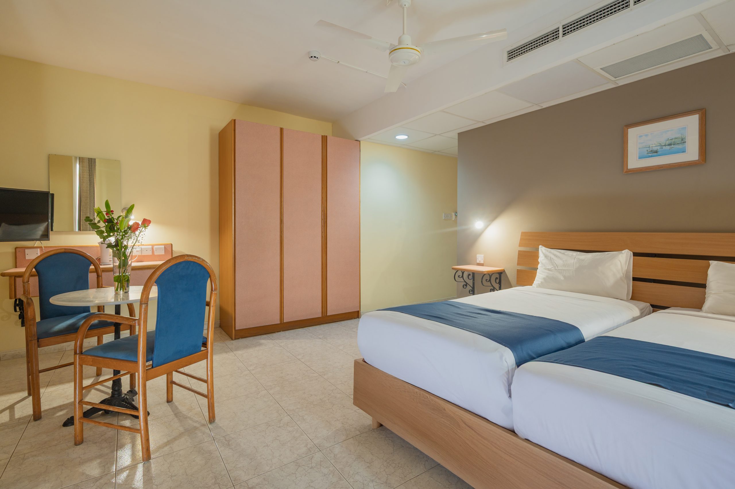Triple Room amenities including desk and TV