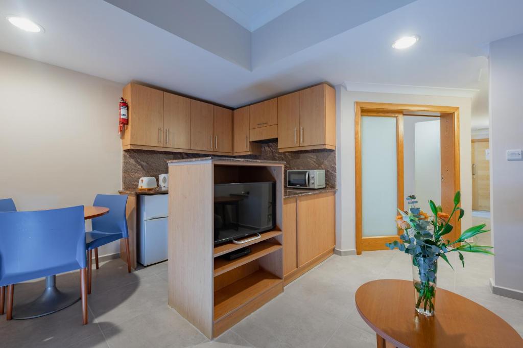 One-bedroom Quadruple Room, living room, pantry, at Xemxija Bay Hotel.